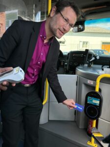 Tapping a Modalis card to test the new transit ticketing system