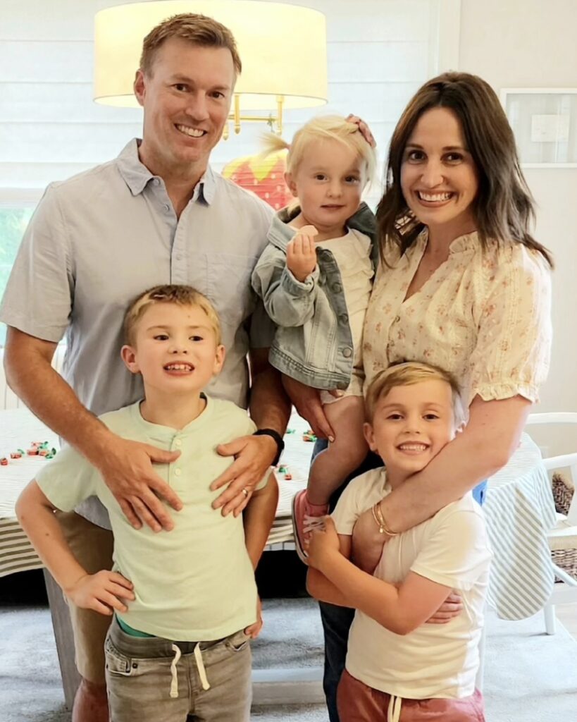 A couple with their three children in a dining room